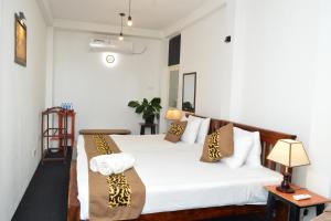 a bedroom with two beds with pillows on them at Namaya Nature Resort & Cafe in Kandy +160 photos