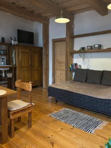 a bedroom with a bed and a table and a chair at Central & Quiet Cēsis Stay in Cēsis