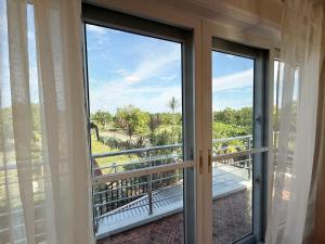 an open door to a balcony with a view at Dolores Cabin & Breakfast in Mactan