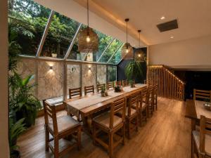 a large dining room with a long table and chairs at Golden Fleece Hotel in Ureki