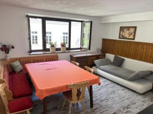 a living room with a table and a couch at Ferienwohnung Walker in Oberdrauburg