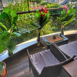 a balcony with a table and chairs and plants at DN Kiten in Kiten