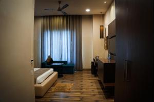 a hotel room with a bed and a window at Silver Palm Hotel & Resorts in Malaut +10 photos