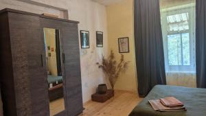 a bedroom with a large wooden cabinet with a mirror at Guest house in Ipnari