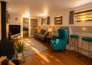 a living room with a couch and a television at Historic Dutch Barge, Idyllic location in London