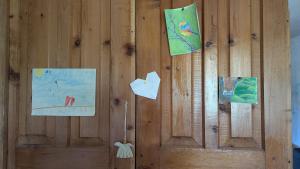 a wooden wall with paintings on it at Guest house in Ipnari +8 photos