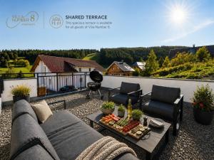 a patio with a couch and chairs and a table at Villa Number 8 in Feldberg