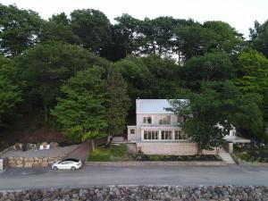 a white car parked in front of a house at VILLA-29 Spa, Sauna, Sunset & Waterfront View in Sainte-Petronille