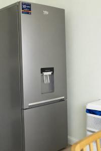 a refrigerator with a dispenser on top of it at Property Reality in London