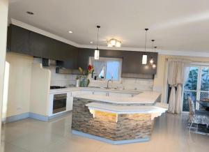 a kitchen with a island in the middle of it at Dolores Cabin & Breakfast in Mactan