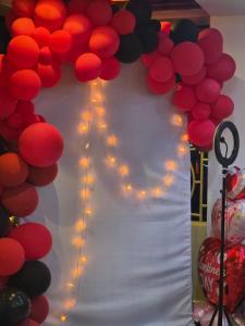 a bunch of red and black balloons with lights at The alder hotel and accommodation in Bungoma