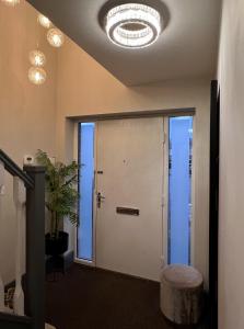 a hallway with a white door and a stool at Luxury Durham Home, Sleeps up to 12, Free Parking in Durham +53 photos