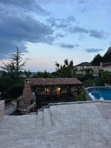 a building with a fireplace next to a swimming pool at The Shefers Residence in Rogachevo +33 photos