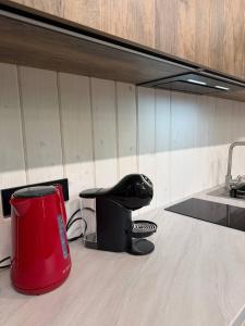 a kitchen with a red stool and a sink at My Dream in Antalovtsi +52 photos