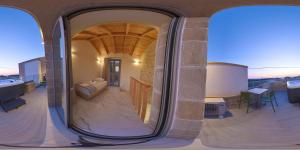 a house with a large round window on a balcony at Faros Elafonisi in Elafonisi
