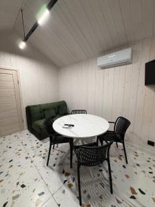 a living room with a table and chairs and a couch at My Dream in Antalovtsi
