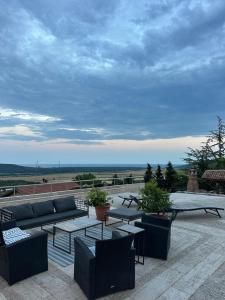 a patio with couches and tables on a roof at The Shefers Residence in Rogachevo