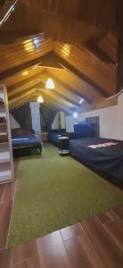 a room with two beds and a green rug at Captain in Ureki
