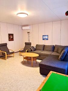 a living room with a couch and a table at Erillinen talo Kiuru in Nilsiä