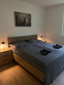 a bedroom with a bed with a deer picture on the wall at Alpinchalet Eisenerz in Eisenerz