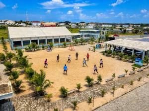 a group of people playing a game on the beach at Westside Beach Resort & Hotel in Mopo Akinlade