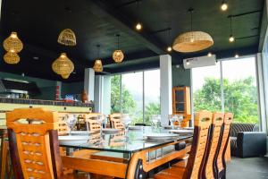 a dining room with a table and chairs and lights at Namaya Nature Resort & Cafe in Kandy