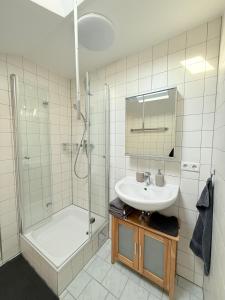 a bathroom with a sink and a shower at Sleep & Go Höchst in Höchst