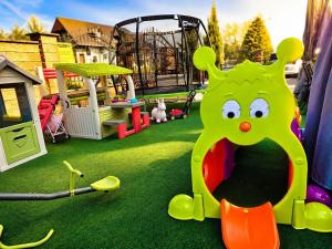 a playground with a play equipment in the grass at Hotel Evan u Hoffera with free parking in Topoľčany