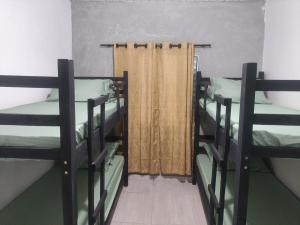 two bunk beds in a room with a window at Casa com churrasqueira – Próx. Shopping Comércios in Várzea Paulista