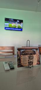 a display case with a book and a remote control at El hogarcito in Cafayate