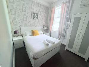 a bedroom with a bed with two towels on it at Cherish Lewis Hotel- Hull Road, Blackpool Central in Blackpool