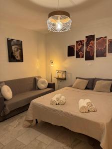 a living room with two beds and a couch at Giannis Philoxenia in Kakí Vígla