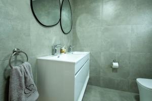 a bathroom with a white sink and a mirror at Culem View's in Eversdal