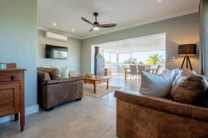 a living room with two couches and a dining room at Culem View's in Eversdal