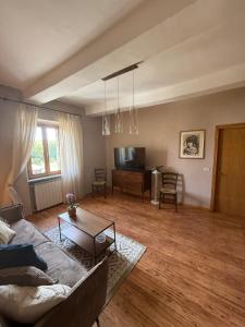 a living room with a couch and a table at La curva del Serpente in Abbadia San Salvatore