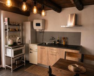a kitchen with a table and a sink and a stove at La Baita Delle Due Valli in Maccagno Superiore