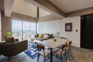 a living room with a table and chairs and a couch at TORRE ARCARTI Internet alta velocidad y estacionamiento in San Baltasar