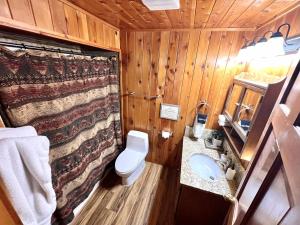 a wooden bathroom with a toilet and a sink at Log Cabin On The Stream Sundance, Utah in Sundance +64 photos