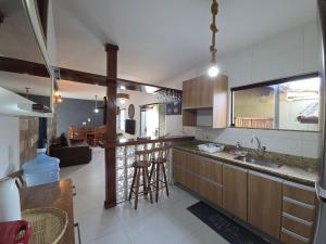 a kitchen with a sink and a counter top at Anexo da Paz Tucuns Búzios in Búzios