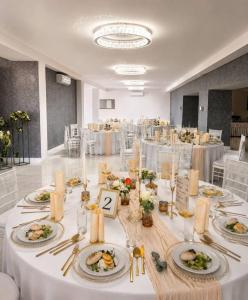 a room with a table with plates of food on it at Hotel Evan u Hoffera with free parking in Topoľčany +22 photos