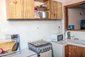 a kitchen with a stove and a microwave at HOBRA HOMEs -Naivasha B in Naivasha