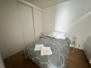 a bedroom with a bed with two towels on it at Le petit rêve in Fours