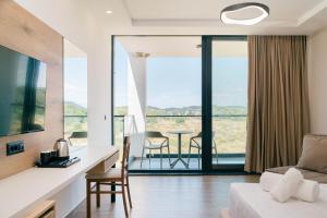 a living room with a couch and a table with chairs at Velmare Inn in Ulcinj