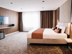 a hotel room with a large bed and a television at Nevv City Hotel in Istanbul