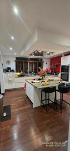 a large kitchen with a table with flowers on it at Superbe Suite parentale Chez l'habitant avec SPA et petit déjeuner in Saint-Pierre +12 photos