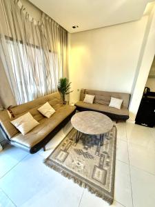 a living room with a couch and a table at شاليهات سمو بارك 2 in Taif