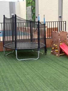 a small playground with a swing set and a slide at شاليهات سمو بارك 2 in Taif +12 photos