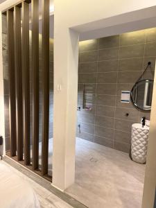a master bedroom with a large shower with gray walls at شاليهات سمو بارك 2 in Taif