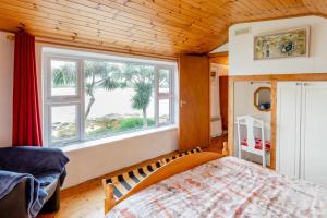 a bedroom with a bed and a large window at 2 Bed in Cashel oc-i223 in Moyrus