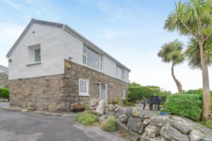 a stone house with palm trees in front of it at 2 Bed in Cashel oc-i223 in Moyrus